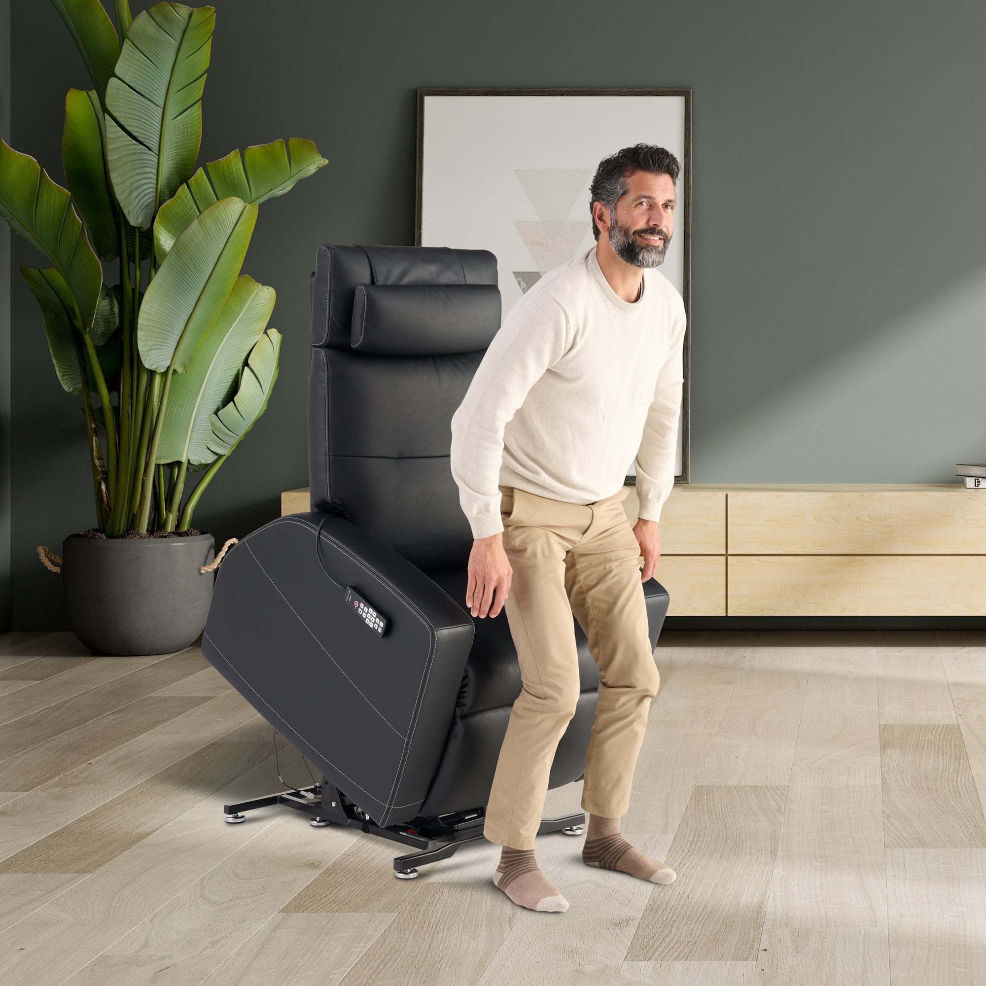 Laevo ZG Chair with Lift Assist shown in modern living room with black leather upholstery and power lift feature