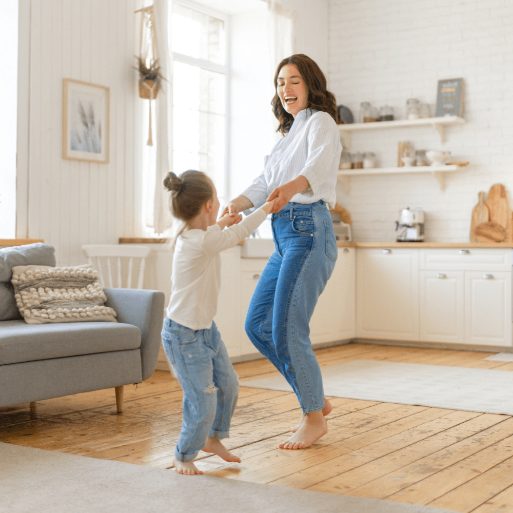 Woman dancing with child in living room